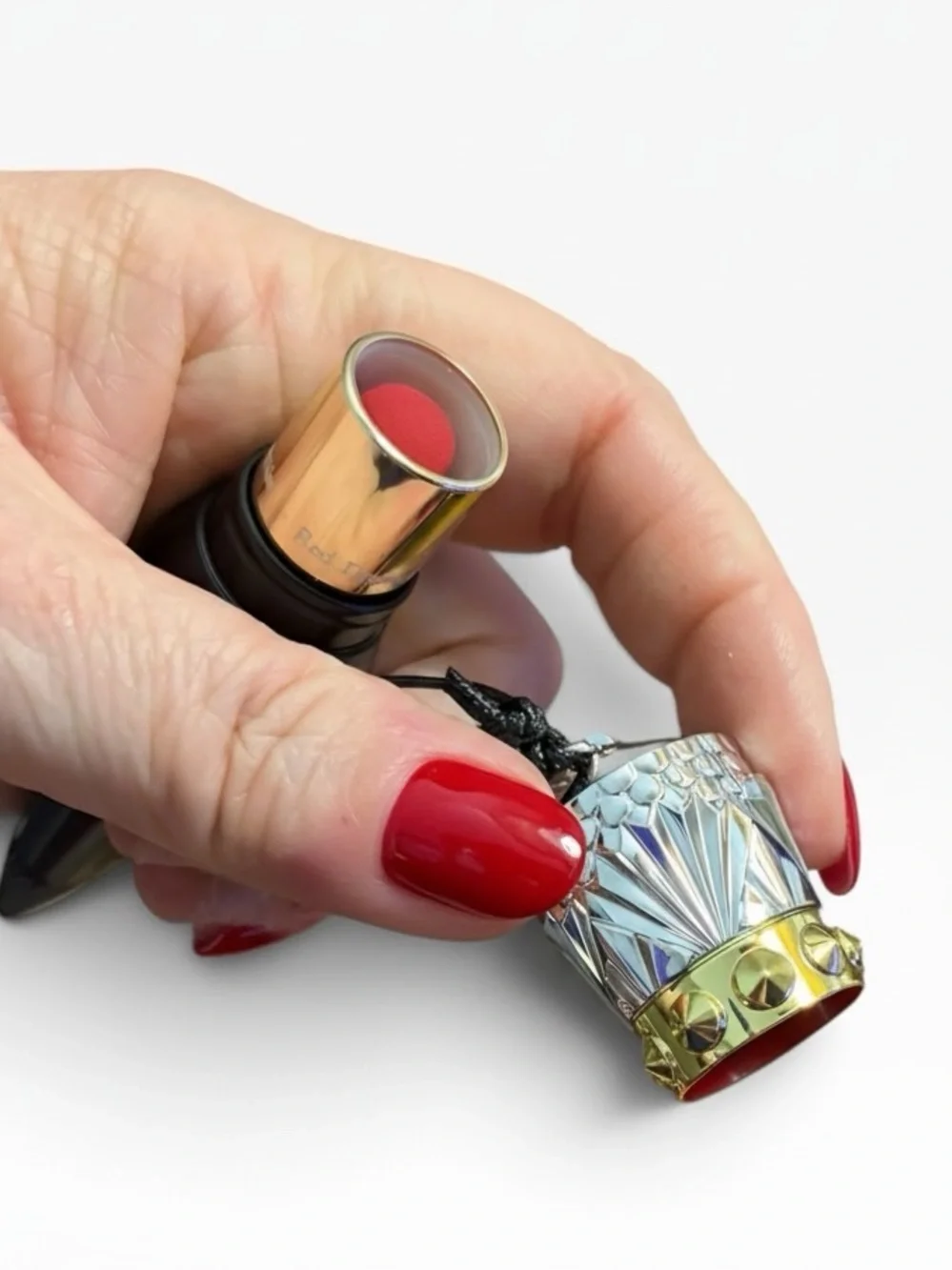 Christian Louboutin Black Spike-Detail Lipstick Holder with red lipstick